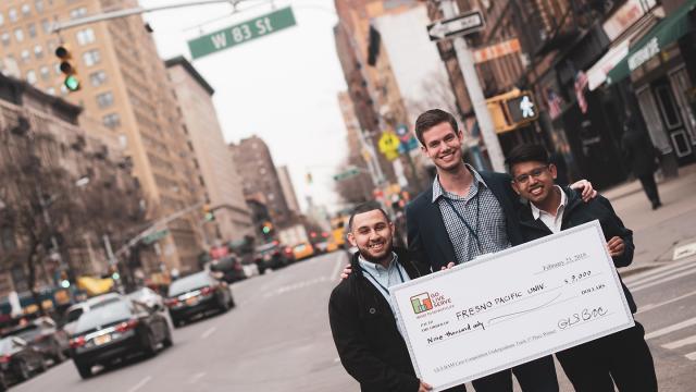 FPU business students (from left) Freddie Lopez, Austin Hussain and Miguel Bermudez  take "big check" of their GoLiveServe winnings to the streets of New York City.