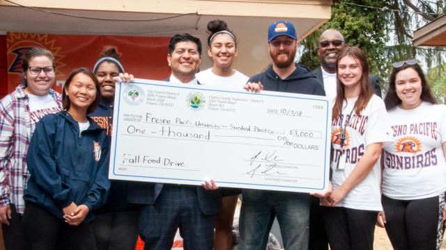 Students celebrate a gift to FPU's Sunbird Pantry with Fresno City Councilmember Luiz Chavez and Angulus Wilson, university pastor