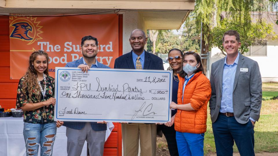 FPU receives check from Fresno City Council Member Luiz Chavez. From left: Maria Ortega, Chavez, President Joseph Jones, Yvette Jones, Jesus Gomez, Brian Davis.