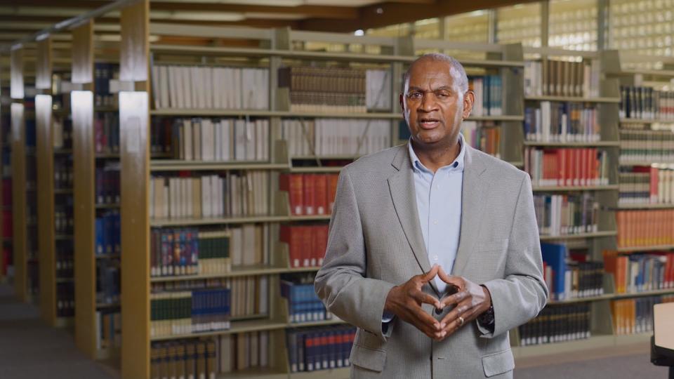 President Joseph Jones, Ph.D., speaking from inside Heibert Library