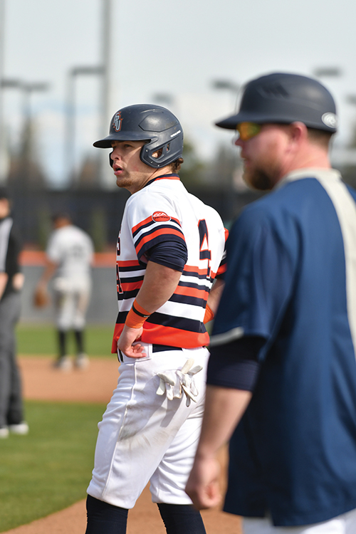 Andrew Valdez thinking and with hands on hips