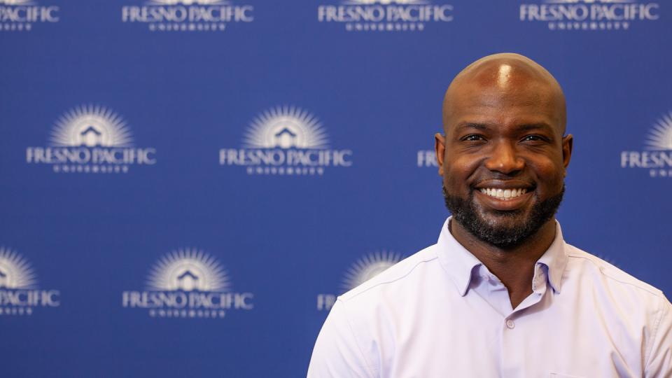 Photo of Andre Payne in front of an FPU-branded backdrop