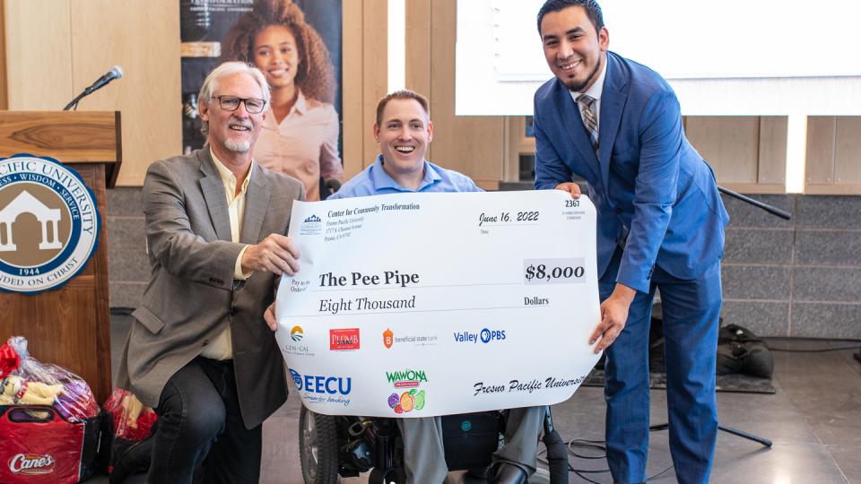 From left: Randy White, D.Min., executive director of the Center for Community Transformation; Scott Johnston, CEO of Pee Pipe; and Carlos Huerta, associate director of CCT, celebrate Johnston's win at the Shark Tank presentation and Microbusiness EXPO.  