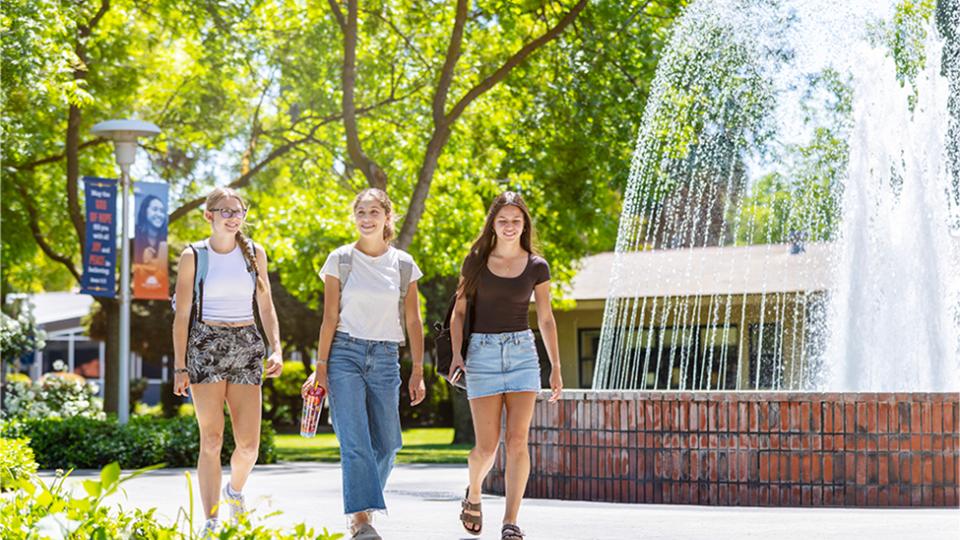 FPU students walk in front of a fountain.