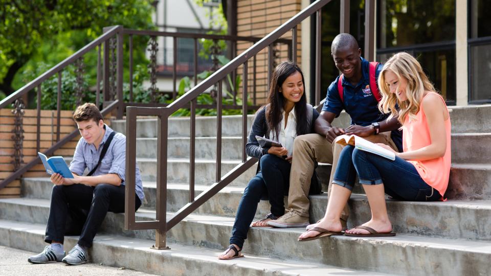 Students studying on the steps of BC Lounge on the main FPU campus