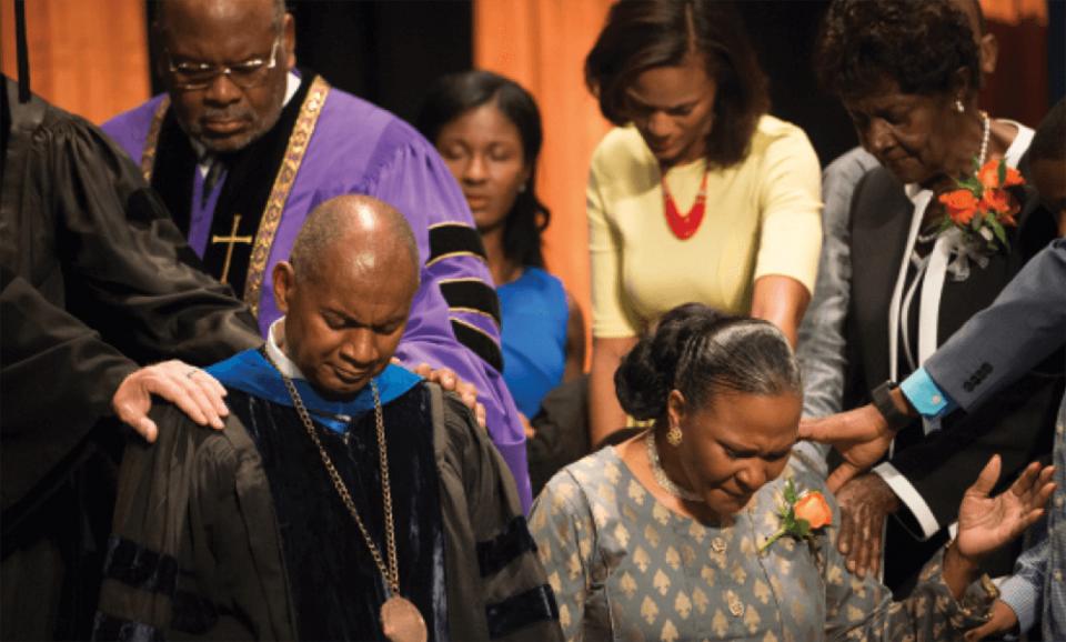 President Joseph Jones and wife Ivette Jones are prayed over at convocation