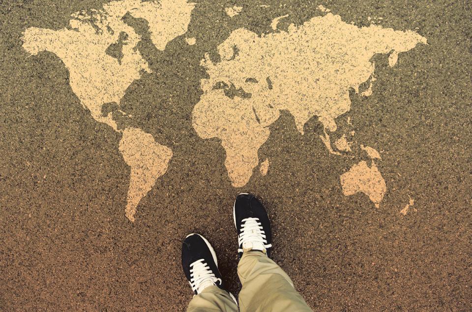 Standing on world map etched in stone