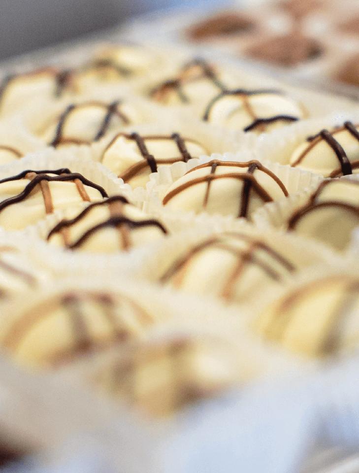 White chocolates with drizzle in paper holders