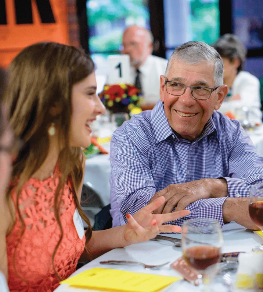 Carlee Clarke speaking with donor at scholarship dinner