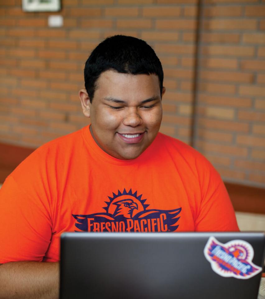 Angel De Leon sitting at a computer