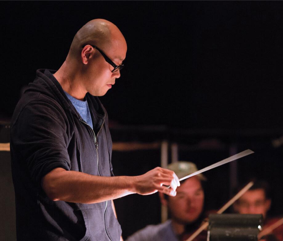 Erik Leung conducting an orchestra