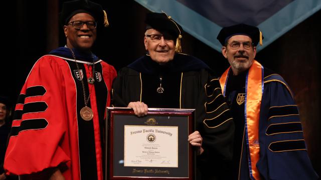 •	Edmund Janzen (center) received an honorary doctorate during the morning commencement ceremony, honoring his career as Fresno Pacific president and faculty member as well a leader in the U.S. Conference of Mennonite Brethren Churches. At left is FPU President André Stephens, Ph.D., and at right is Josh Wilson, J.D., chair of the FPU Board of Trustees. 