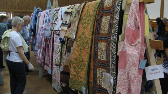 Mennonite quilts hung on display in Special Events Center for MCC Sale
