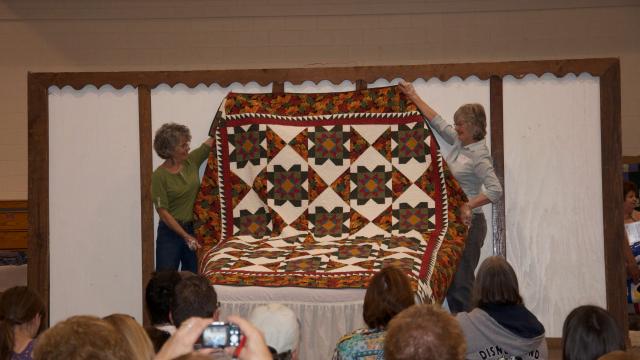 Mennonite quilt displayed for auction in Special Events Center during MCC Sale