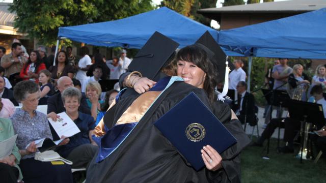 FPU grads hugging at commencement