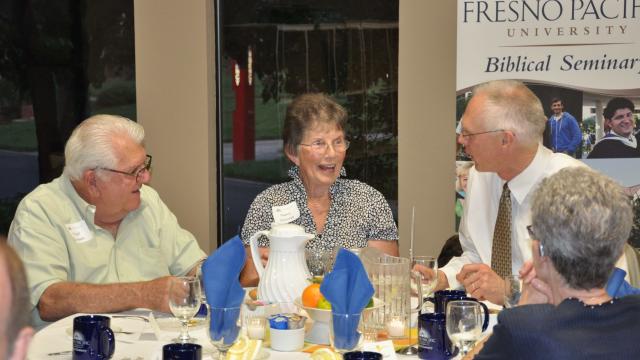 From left, Virgil and Nancy Goossen visit with Jost.