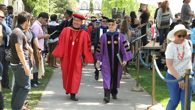President Pete Menjares and Provost Steve Varvis walk in regalia