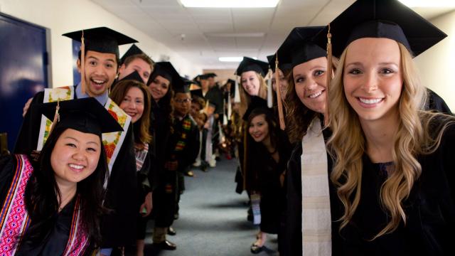 FPU Graduates group picture in hallway before Commencement