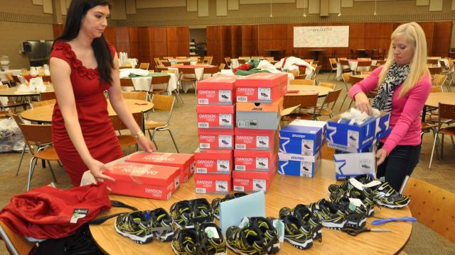 Nayely Carlos and Ali Sena arrange shoes donated for Soled Out for Kids event