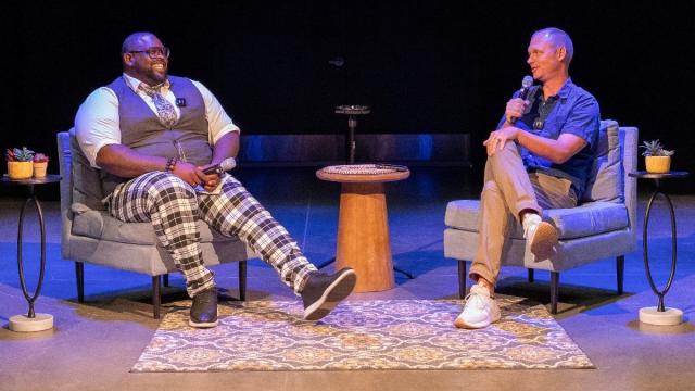 Right to left: D.J. Criner and Brian Ross have a discussion while sitting in chairs..