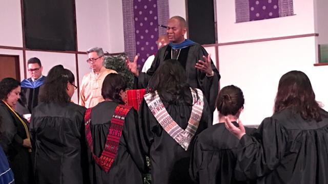 President Joseph Jones leading prayer at Baccalaureate Ceremony