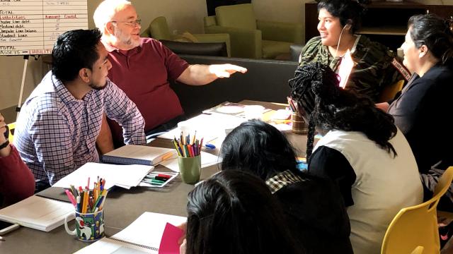 A group of people talking around a table