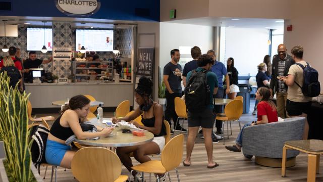 An overall shot of Charlotte's Coffee Corner filled with students, faculty and staff shows off the renovations described in the text. 