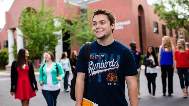 Students in front of McDonald Hall on the main FPU campus