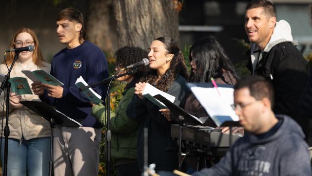 Pictured is Jon Shabaglian (standing at right, behind the drummer) and student members of the university worship band.