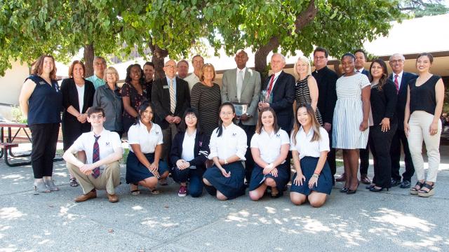 Adminstrators, faculty, staff and students from San Joaquin Memorial High School pose with leaders of Fresno Pacific University to celebrate international students partnership.