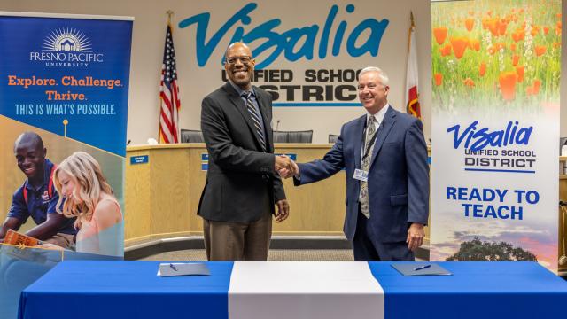 PHOTO: (From left) FPU President André Stephens, Ph.D., and VUSD Superintendent Kirk Shrum shake hands after signing a Memo of Understanding setting up a pathway for district students to be accepted and offered financial aid at the university. (Photo courtesy VUSD)