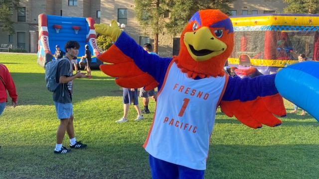 Sunny ther Sunbird welcomes alumni and community visitors to the Campus Green for Gather '23
