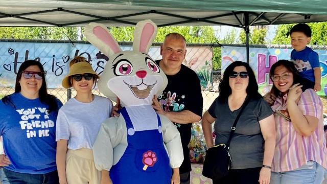 Easter giveaway organizers pose with the Easter Bunny 