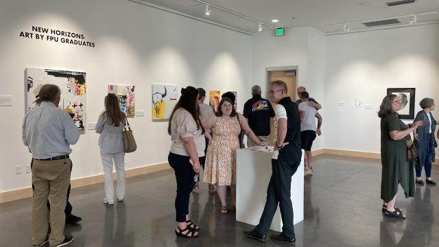 Guests enjoy paintings in Ewert Art Gallery in the Warkentine Culture and Arts Center