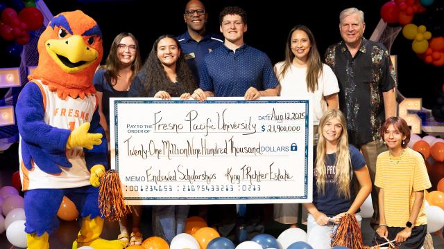 People surrounding a big check celebrating FPU&#039;s largest financial gift.