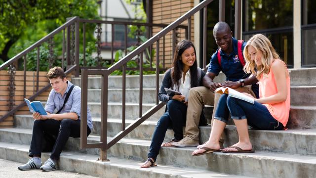 Students studying on the steps of BC Lounge on the main FPU campus