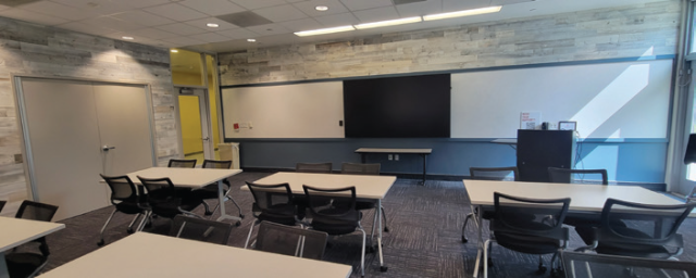 A classroom with two whiteboards