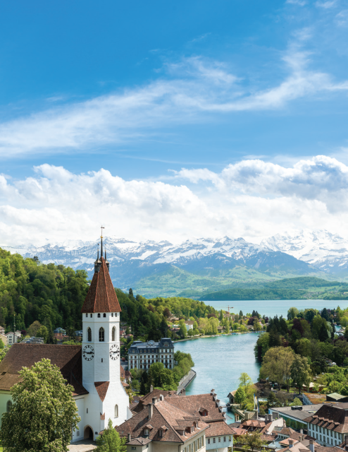 Switzerland a river and grassy mountains in the back