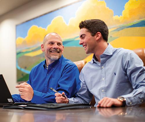 Two men looking at a computer